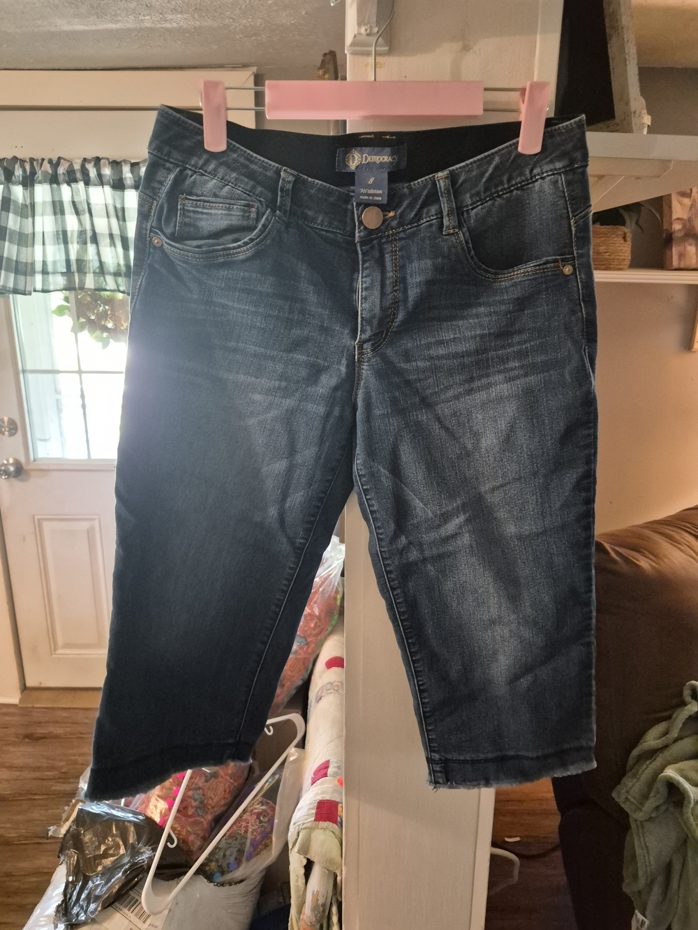 Democracy brand mid-rise capri jeans featuring a dark wash and a comfortable